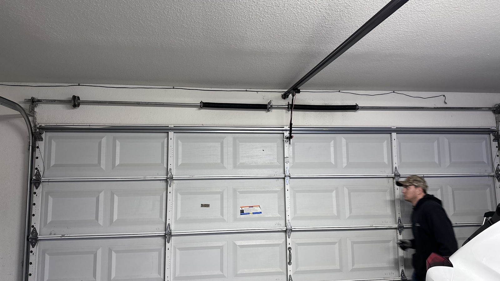 Technician inspecting the inside of a sectional garage door