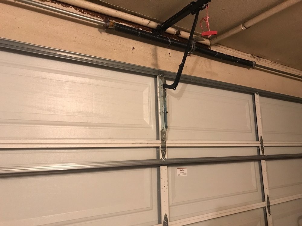 Interior of an installed sectional garage door with hinges, track and opener rail