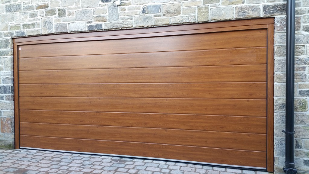 Oak sectional garage door installed in a stone opening